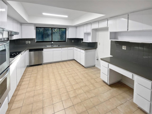 kitchen featuring white cabinets, decorative backsplash, stainless steel appliances, and sink