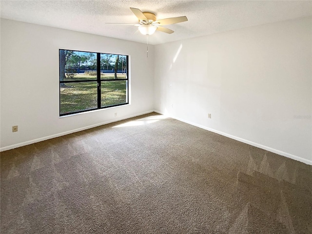 empty room featuring carpet, a textured ceiling, and ceiling fan