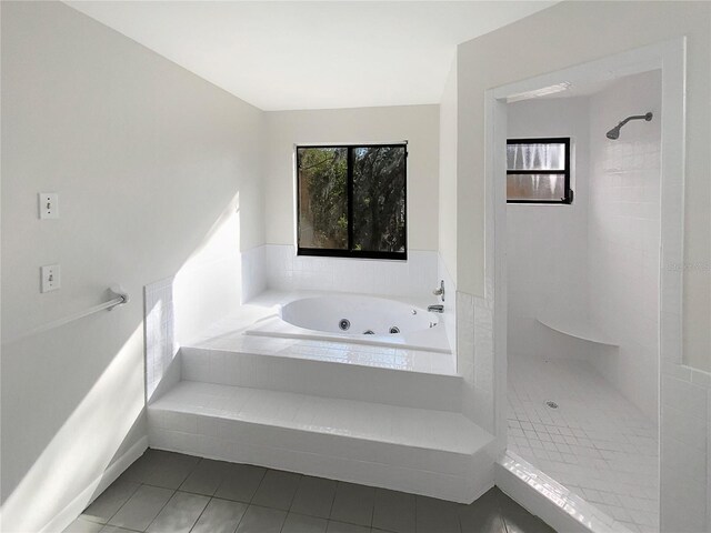 bathroom featuring tile patterned flooring and shower with separate bathtub