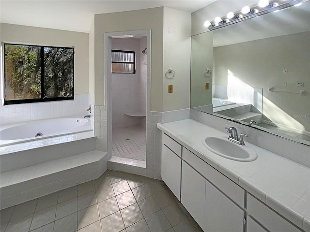 bathroom with tile patterned floors, vanity, and independent shower and bath