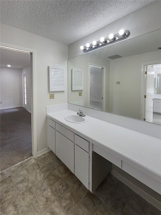 bathroom featuring vanity and a textured ceiling