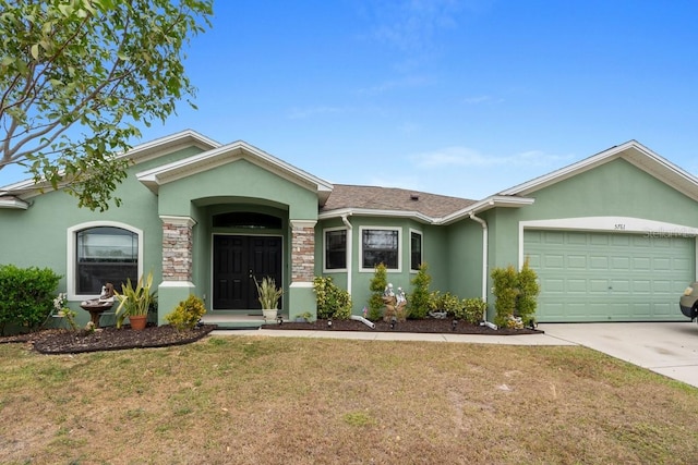 ranch-style home featuring a front lawn and a garage