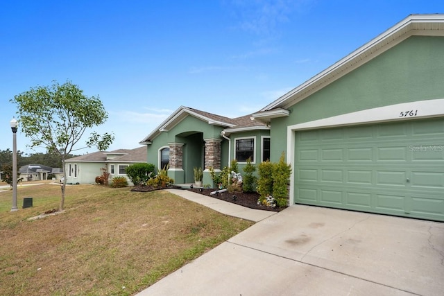 single story home with a garage and a front lawn