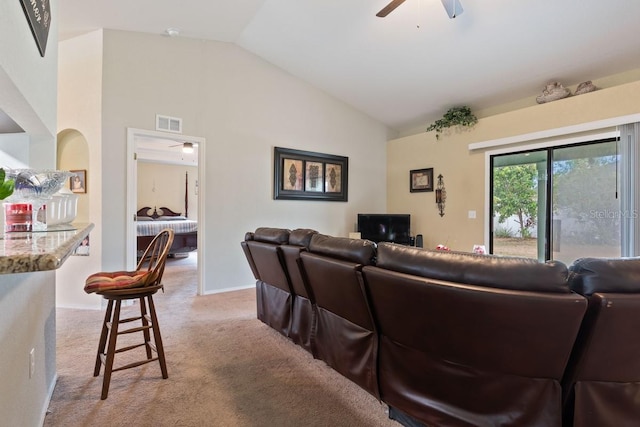 living room featuring ceiling fan, light colored carpet, and lofted ceiling