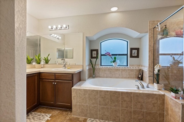 bathroom with vanity and independent shower and bath