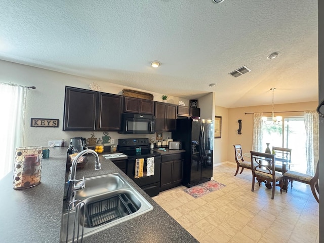 kitchen featuring a textured ceiling, sink, black appliances, a chandelier, and hanging light fixtures