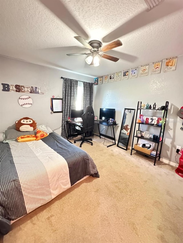 carpeted bedroom featuring ceiling fan and a textured ceiling