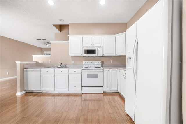 kitchen with white appliances, white cabinets, sink, light hardwood / wood-style flooring, and ceiling fan