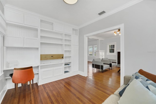 living room with a notable chandelier, wood-type flooring, and ornamental molding