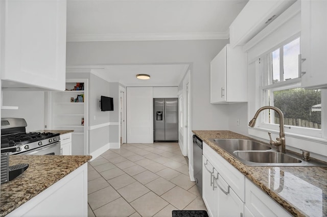 kitchen featuring dark stone countertops, sink, white cabinetry, and stainless steel appliances