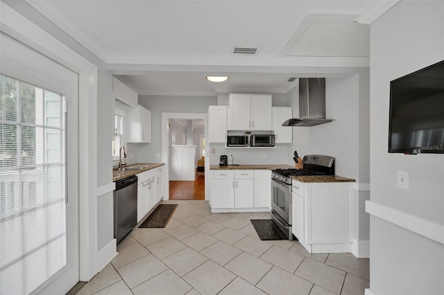 kitchen featuring white cabinets, sink, wall chimney exhaust hood, and appliances with stainless steel finishes