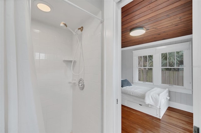 bathroom featuring hardwood / wood-style floors, wood ceiling, and walk in shower