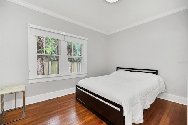 bedroom featuring dark hardwood / wood-style flooring and ornamental molding