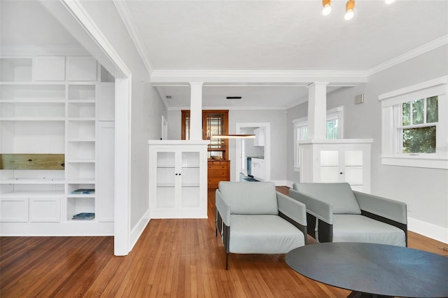 living room featuring hardwood / wood-style flooring and crown molding