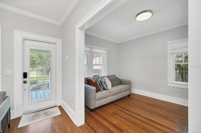 entrance foyer with dark hardwood / wood-style floors and crown molding