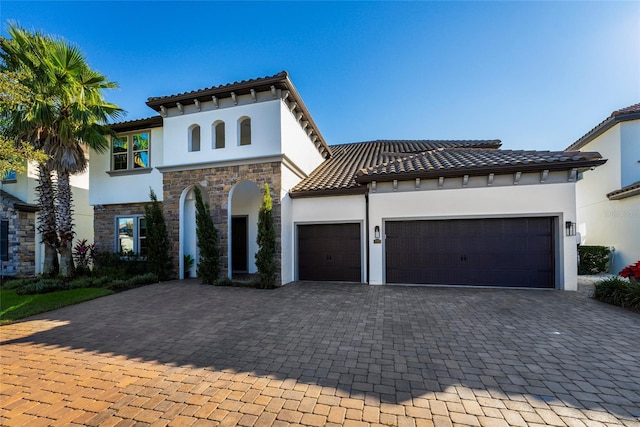 mediterranean / spanish-style house featuring a garage