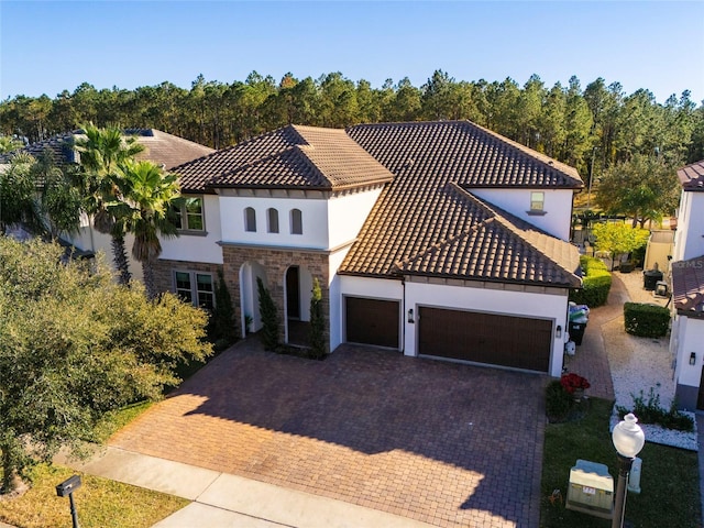 mediterranean / spanish-style house with a garage