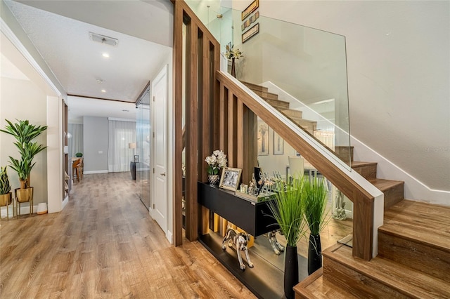 stairway with hardwood / wood-style flooring