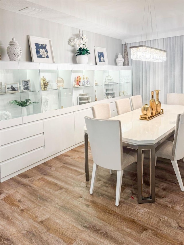 dining area featuring an inviting chandelier and light wood-type flooring