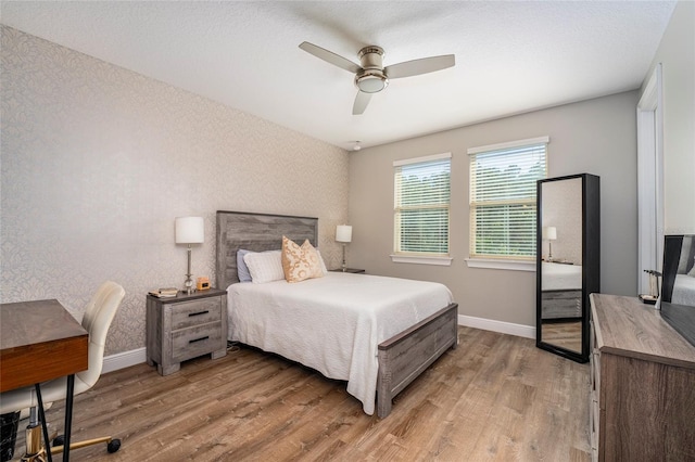 bedroom with hardwood / wood-style floors and ceiling fan