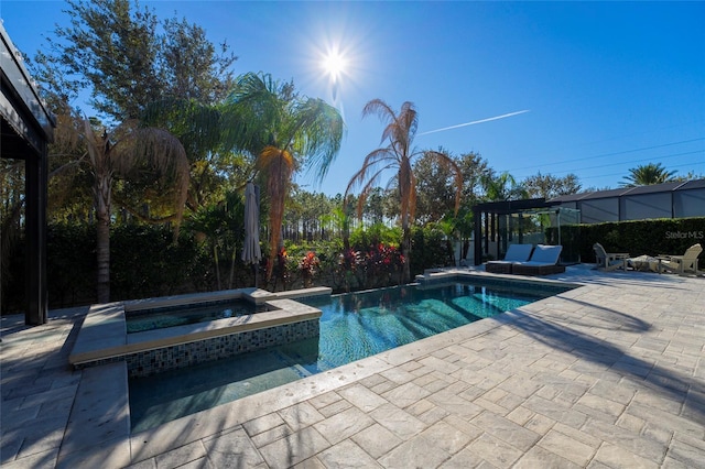 view of pool with a patio area and an in ground hot tub