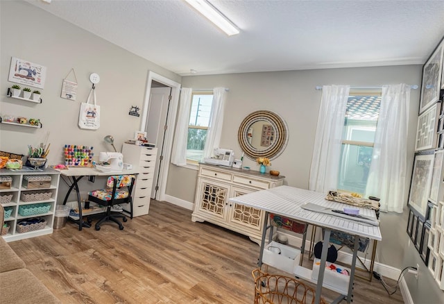 office featuring a wealth of natural light, hardwood / wood-style floors, and a textured ceiling