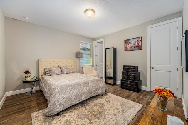 bedroom with dark hardwood / wood-style flooring