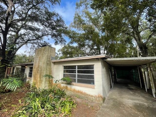 view of property exterior featuring a carport