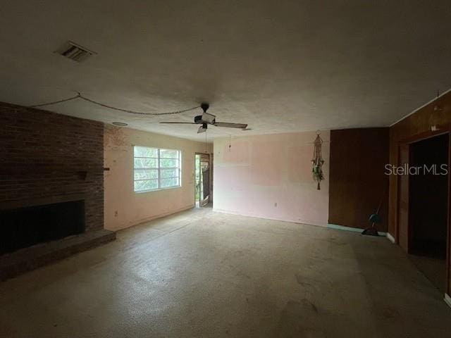 unfurnished living room with a fireplace and ceiling fan