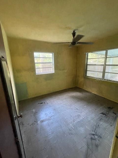 unfurnished room with ceiling fan