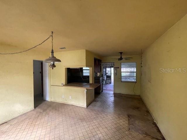 kitchen featuring kitchen peninsula and ceiling fan