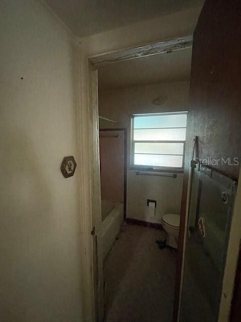 bathroom featuring toilet and walk in shower