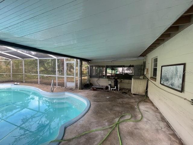 view of pool with a lanai and a patio area