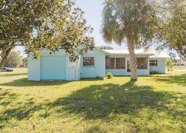 view of front of home featuring a garage and a front lawn