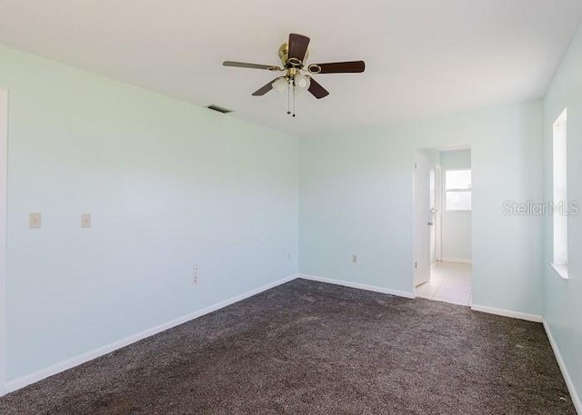 unfurnished room featuring light carpet and ceiling fan