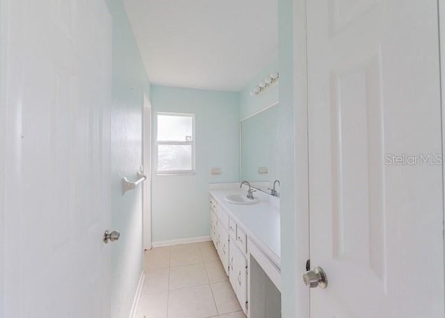 bathroom with tile patterned flooring and vanity