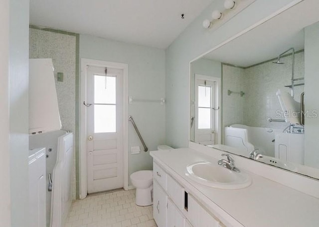 bathroom featuring tile patterned flooring, vanity, and toilet