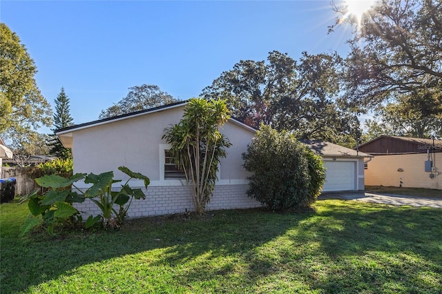 view of home's exterior featuring a lawn and a garage