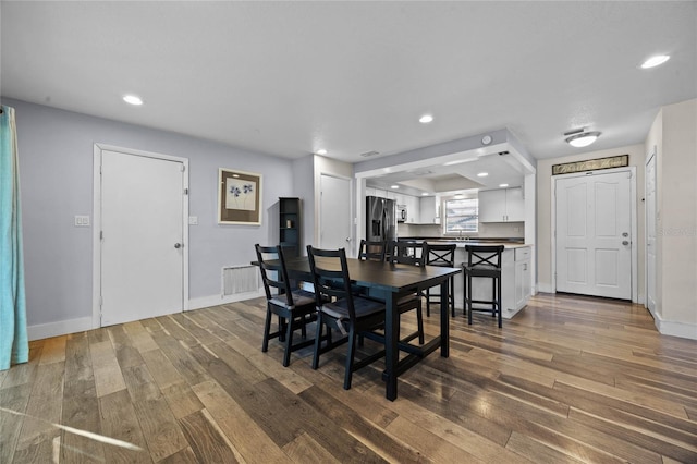 dining area with dark hardwood / wood-style flooring