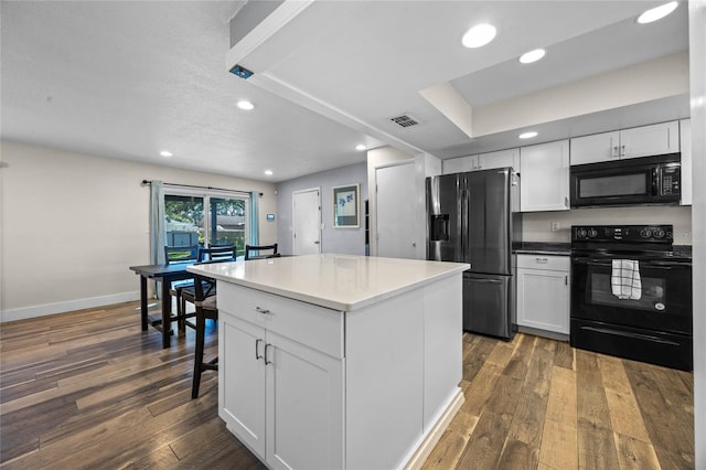 kitchen with dark wood-type flooring, a center island, white cabinets, and black appliances