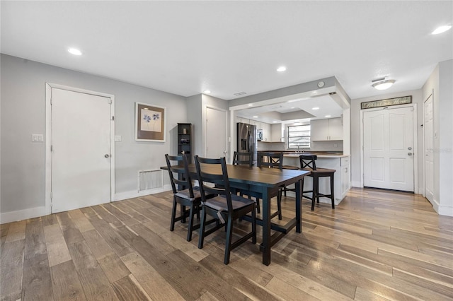 dining space featuring light hardwood / wood-style floors