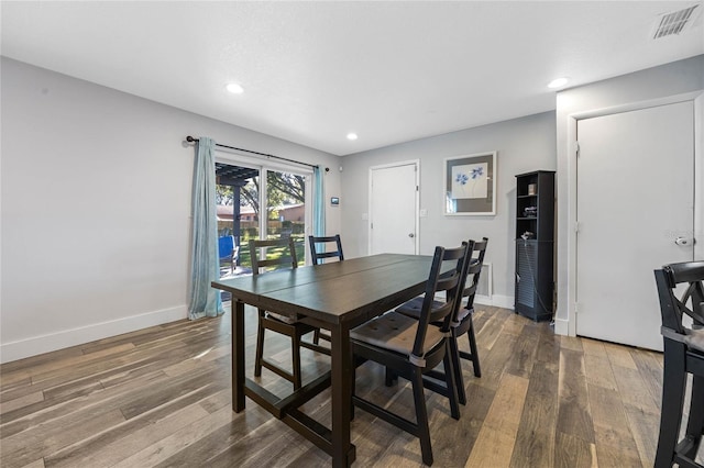 dining area with dark hardwood / wood-style floors