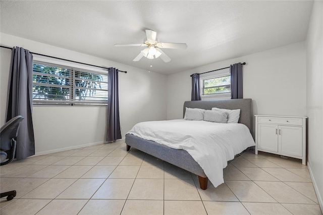 bedroom with ceiling fan and light tile patterned floors