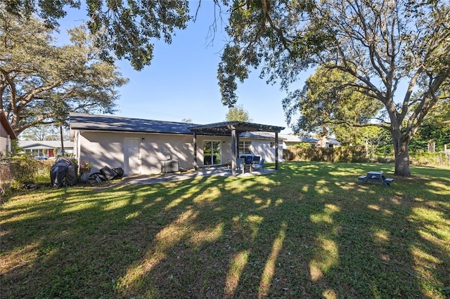 back of property with a pergola, a yard, and a patio