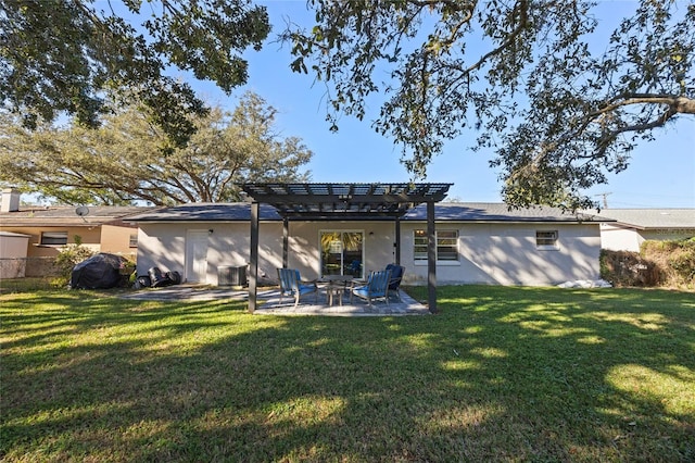 back of property featuring a patio area, a yard, and central AC