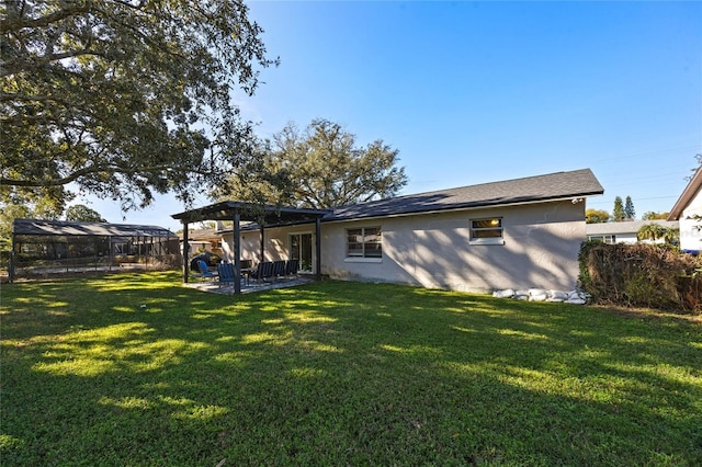 back of house featuring a pergola, a yard, and a patio