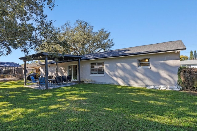 rear view of property featuring an outdoor living space, a yard, and a patio