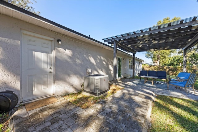 view of patio / terrace featuring a pergola and central AC unit