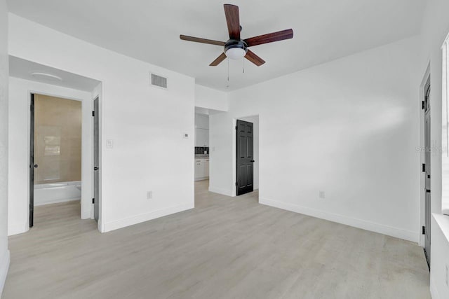 unfurnished bedroom featuring ensuite bath, ceiling fan, and light hardwood / wood-style floors