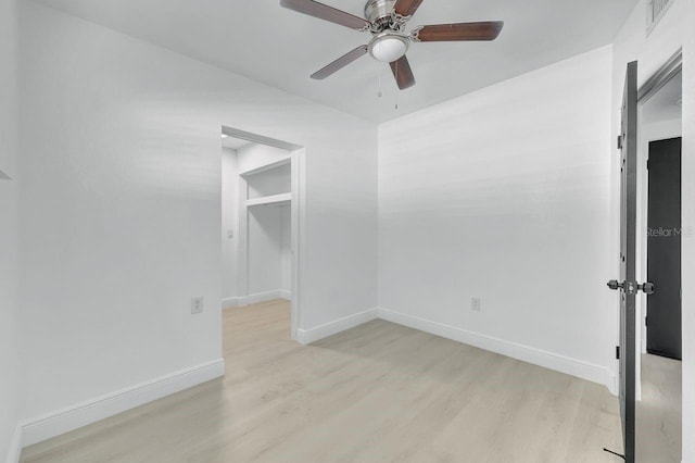 empty room with light hardwood / wood-style flooring and ceiling fan